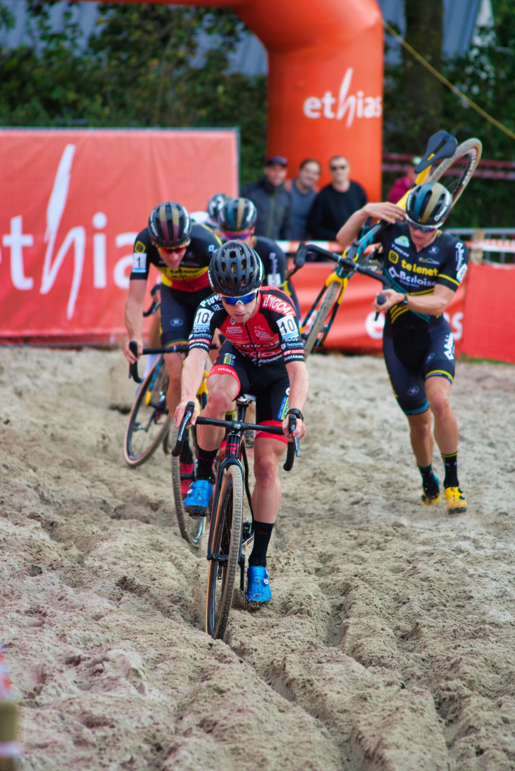 Several cyclists on the sand at a cyclocross event
