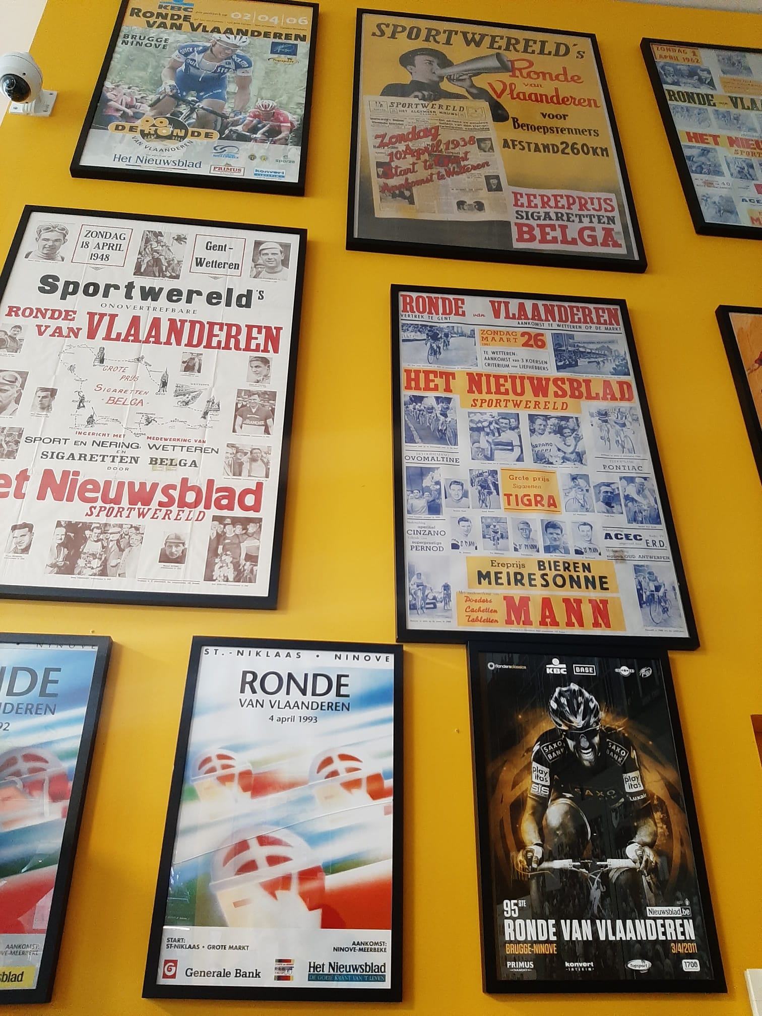 A wall with different pictures in the Tour of Flandes museum in Oudenaarde
